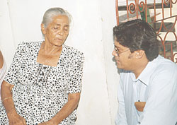  Neil Kumar as he comforts the missing taxi driver's grandmother.